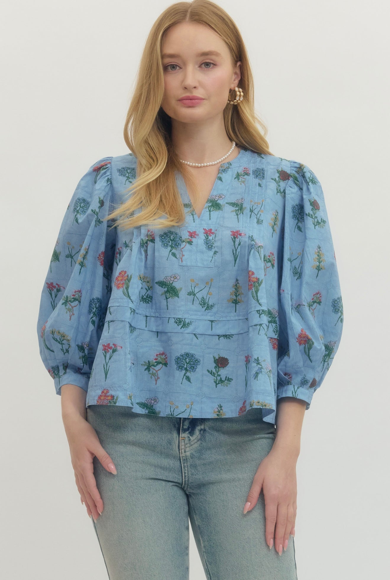 Chambray Floral Top, a soft blue floral empire waist blouse, worn front view