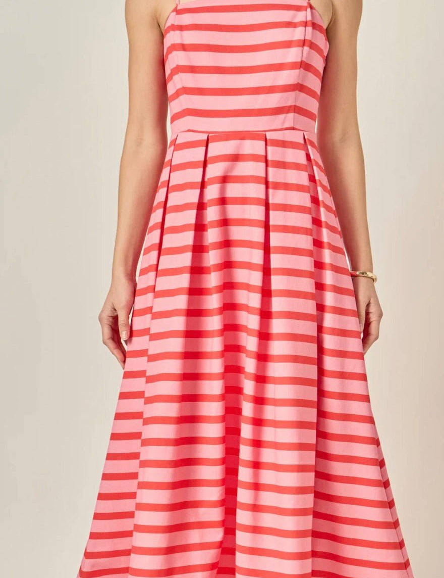 Back view of the Pretty In Stripes Dress, a striped pleated midi with spaghetti straps