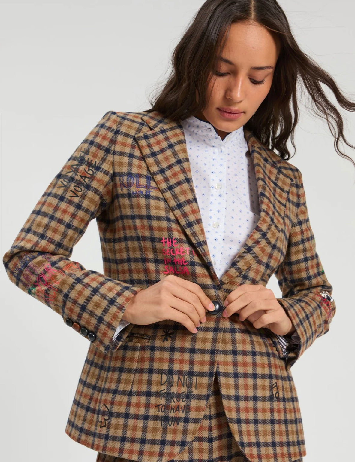 Graffiti Plaid Jacket, a tan plaid blazer with embroidered phrases, worn front view