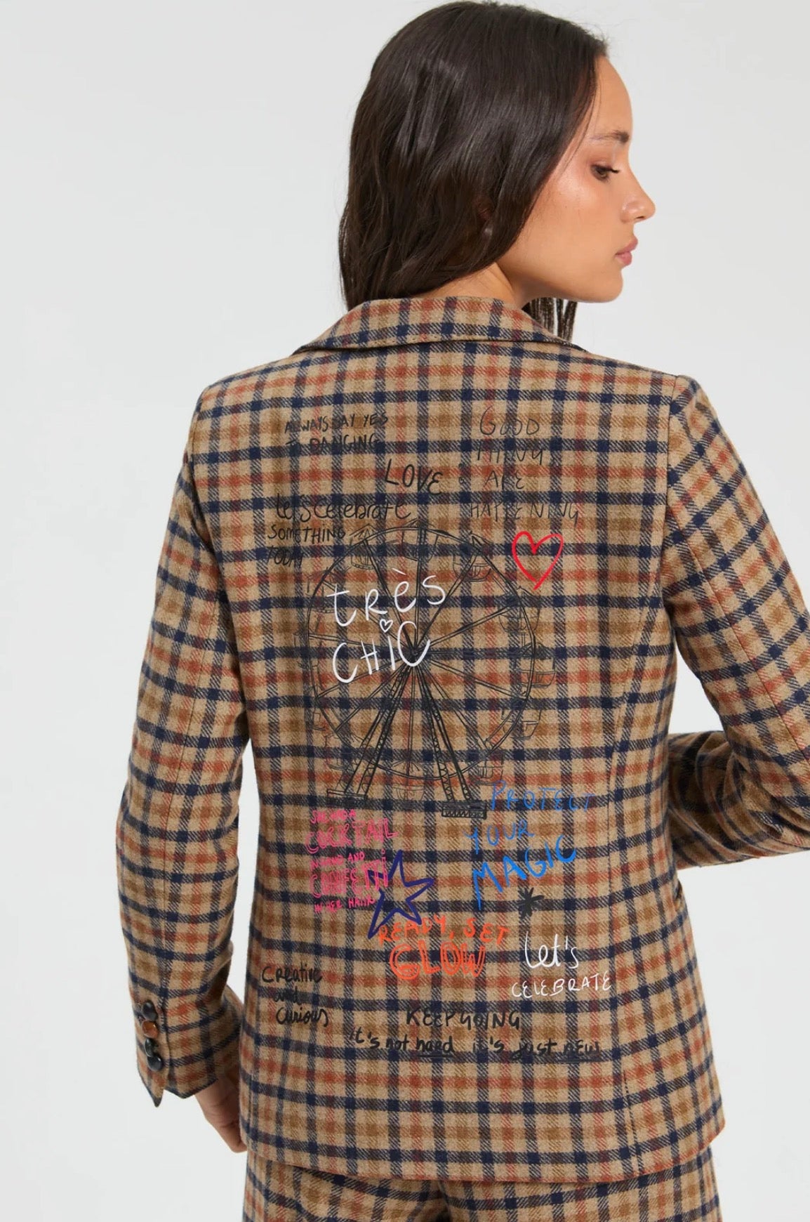 Back view of the Graffiti Plaid Jacket, a tan plaid blazer with embroidered phrases