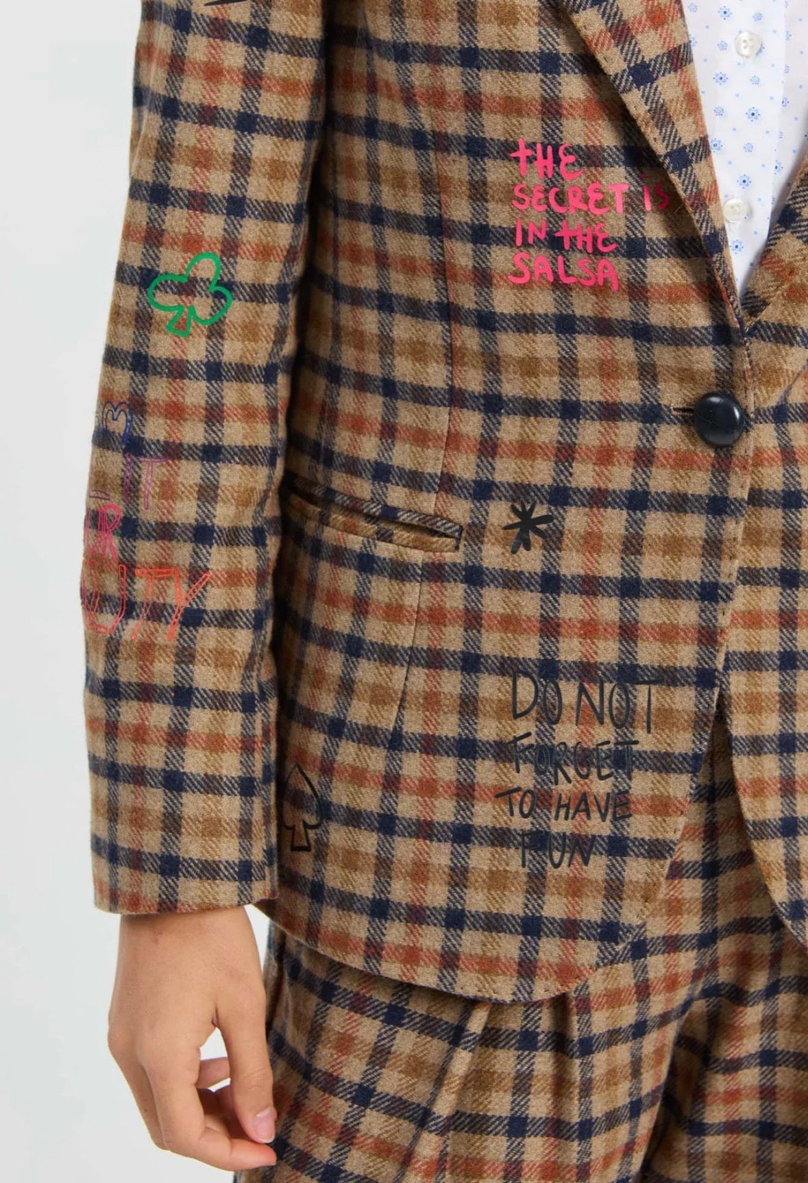 Close-up of the embroidered phrases and hearts on the Graffiti Plaid Jacket